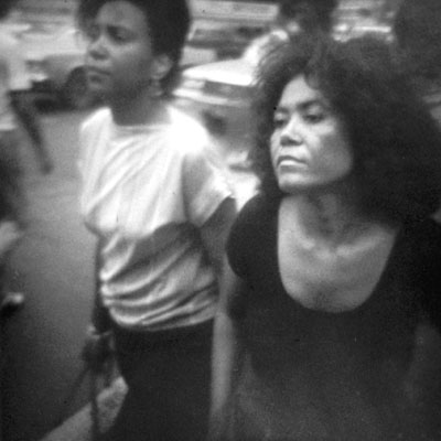 women pedestrians in a midtown Manhattan crosswalk on a hot day in 1983